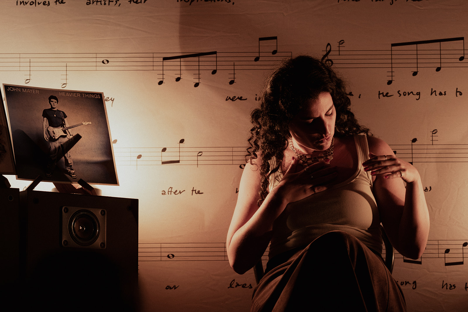 A storyteller on stage beside a record sleeve