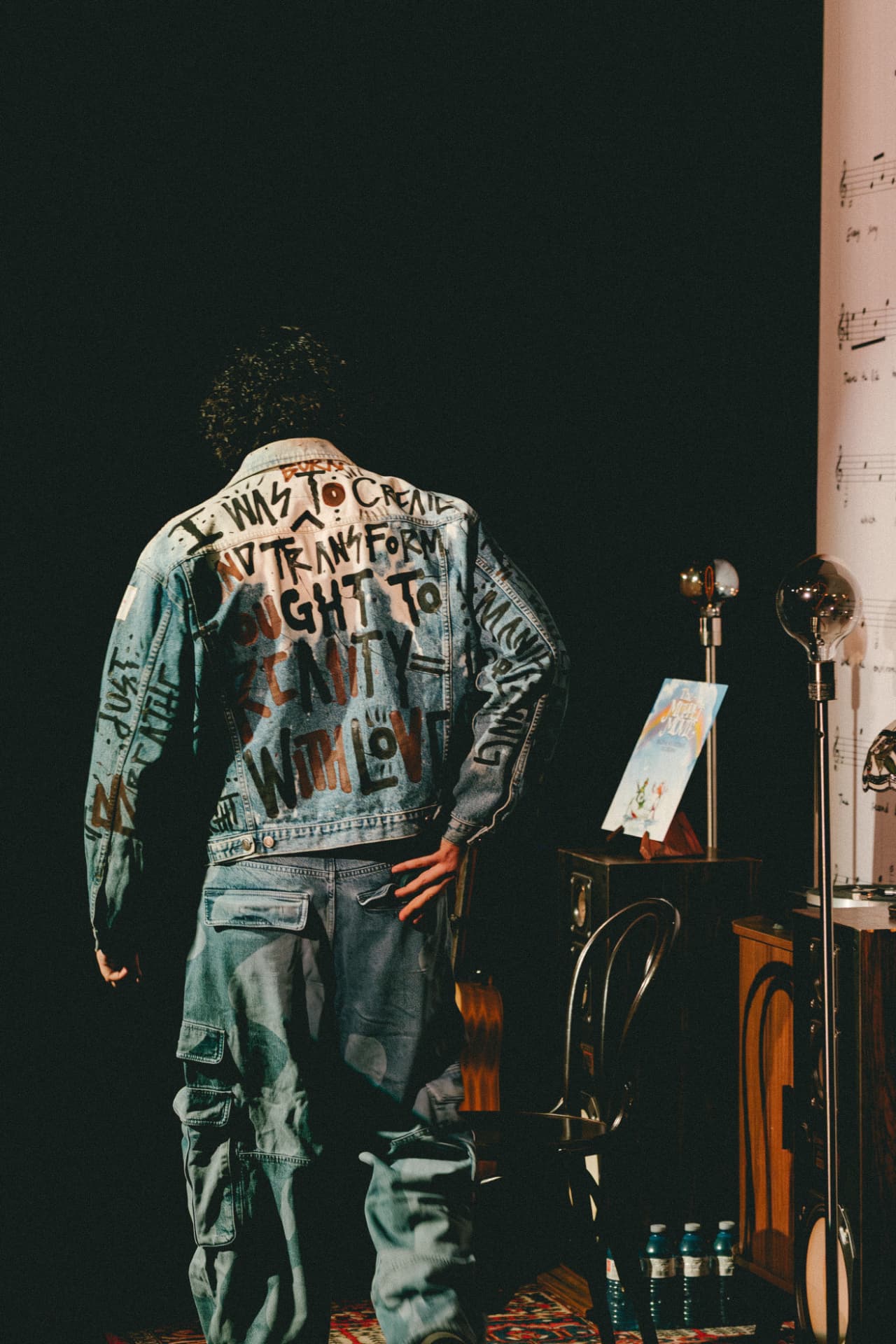 A storyteller in a hand-painted denim jacket