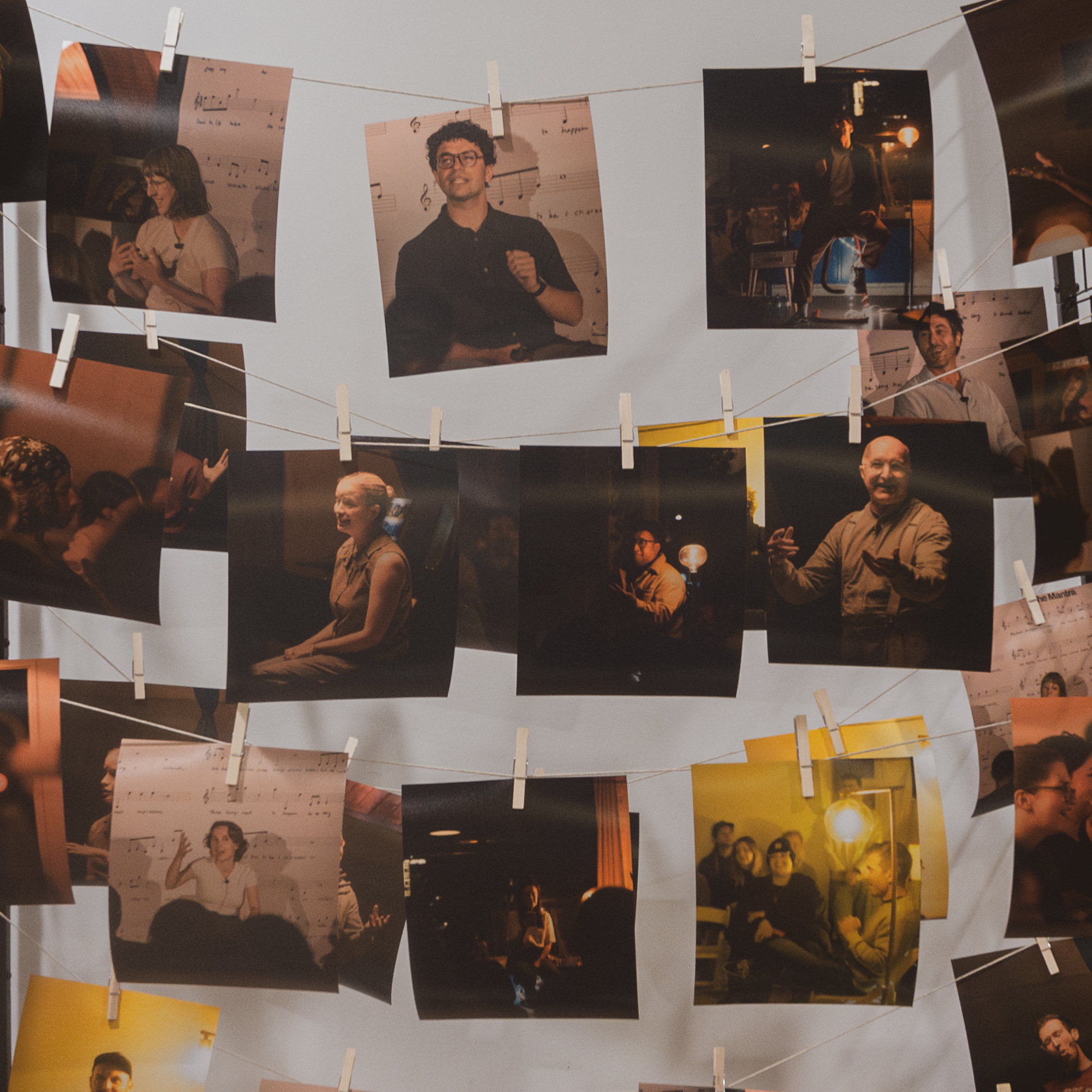 Printed show photos hanging on a line